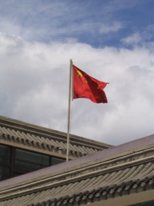 chinese flag flying on top of a building