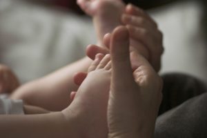 mothers hands and baby's feet